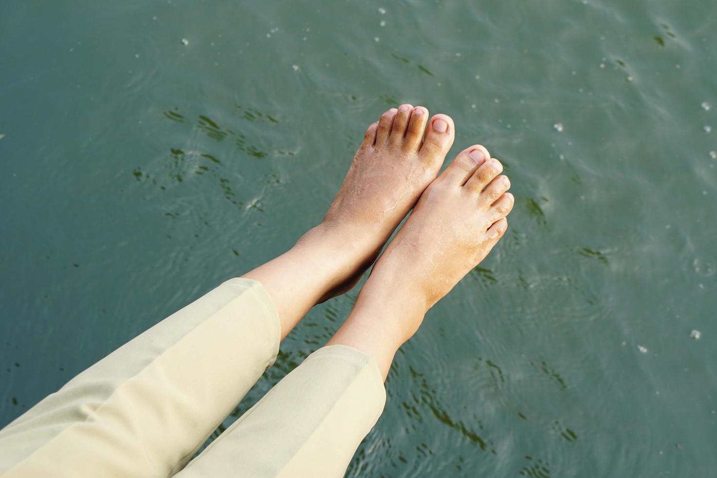 female tourist feet river background photo