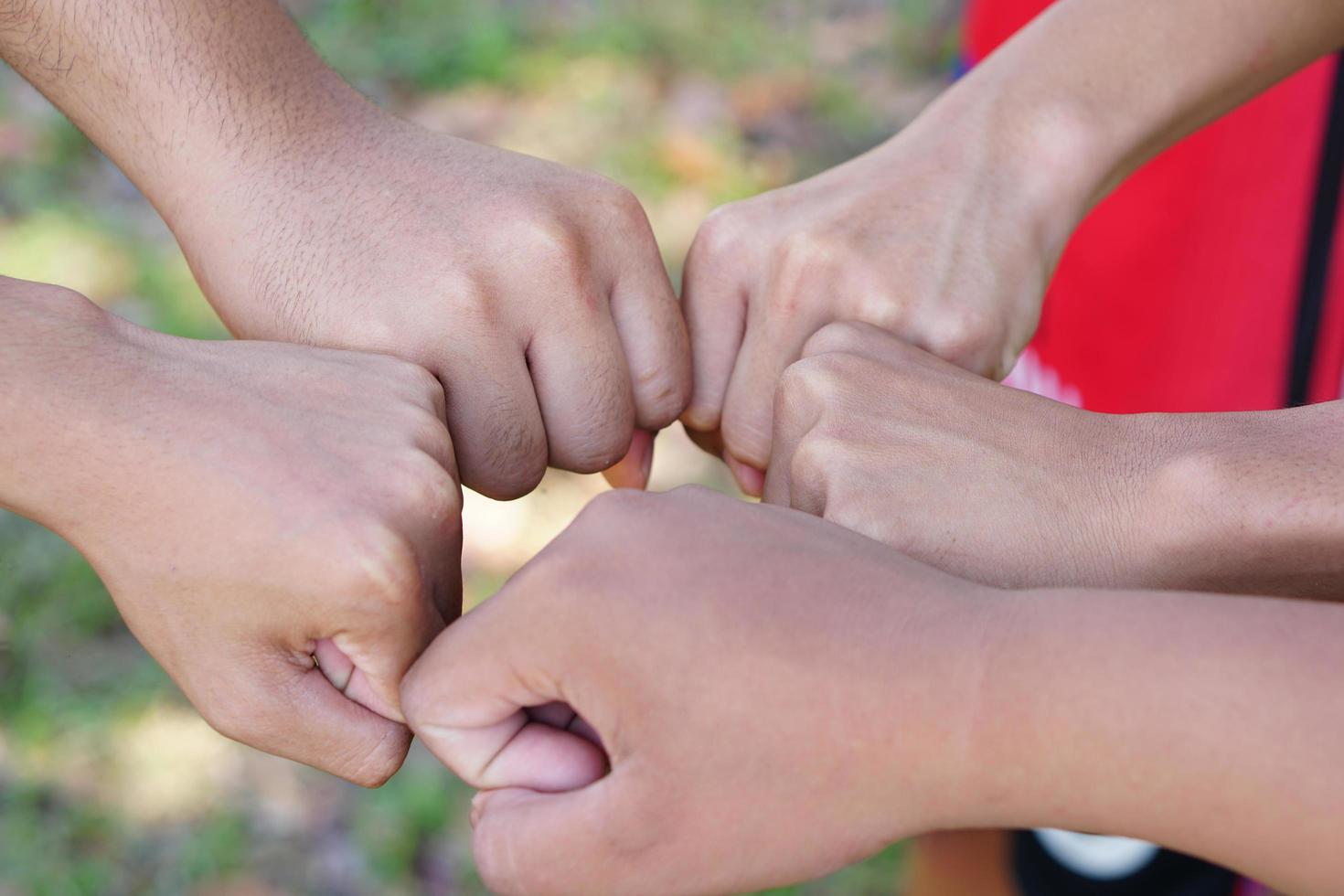college students working as a team stacking hands concept photo