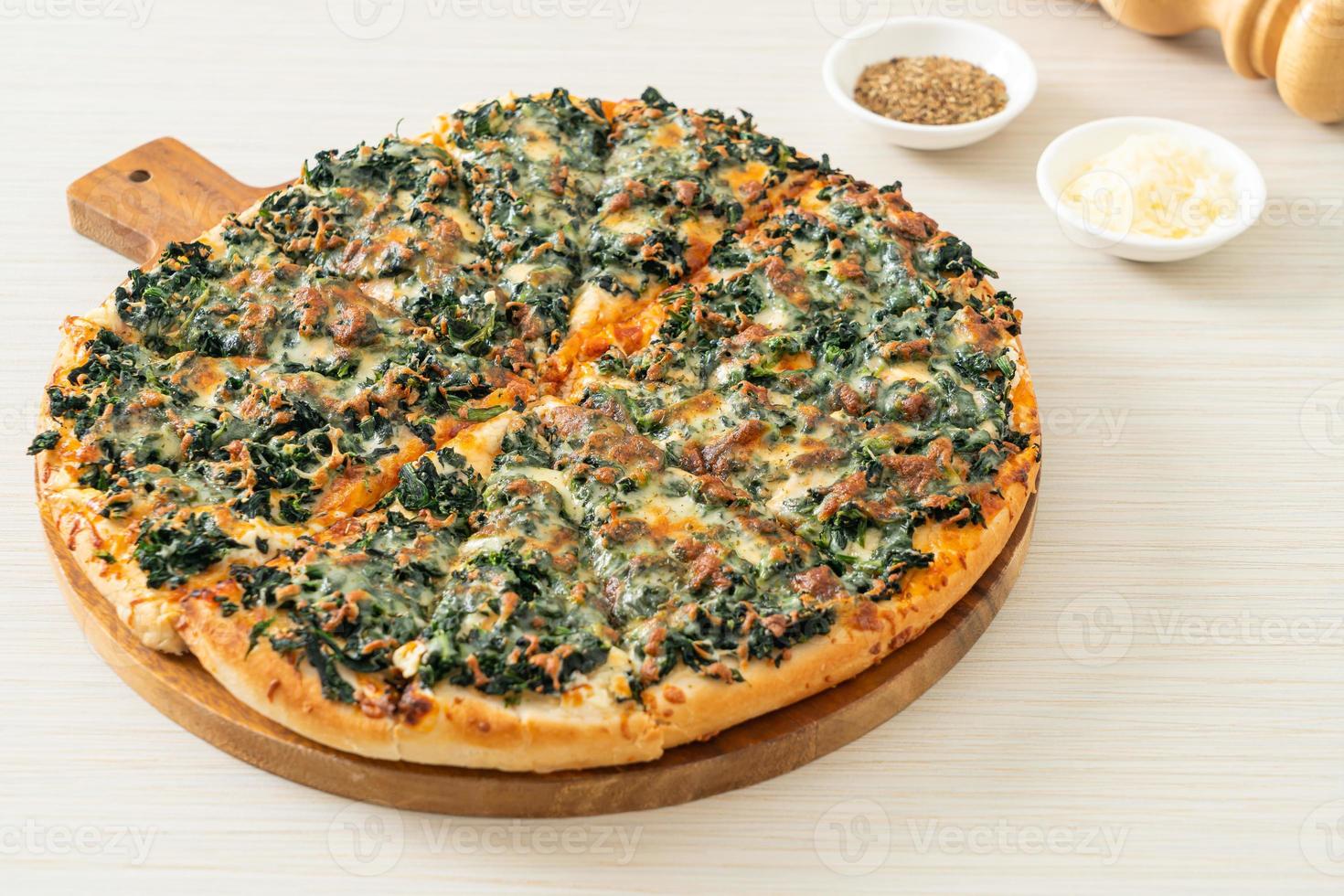 spinach and cheese pizza on wood tray photo