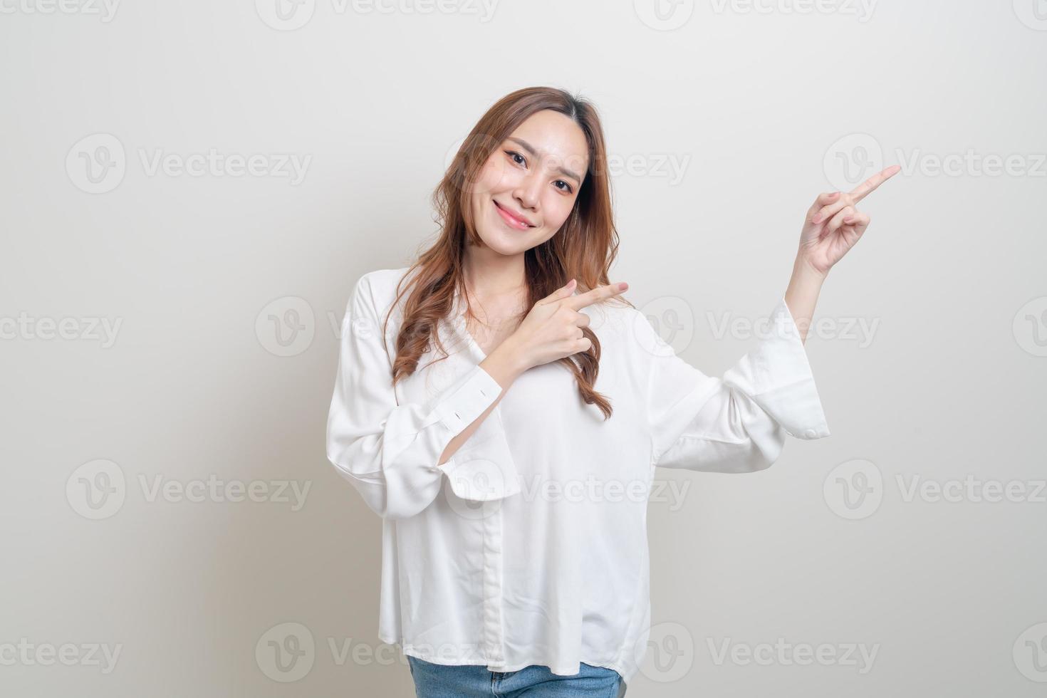 portrait beautiful woman with hand presenting or pointing photo