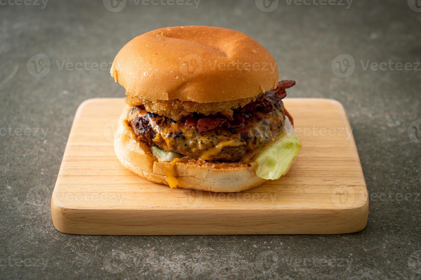 beef burger with cheese, bacon and onion rings photo