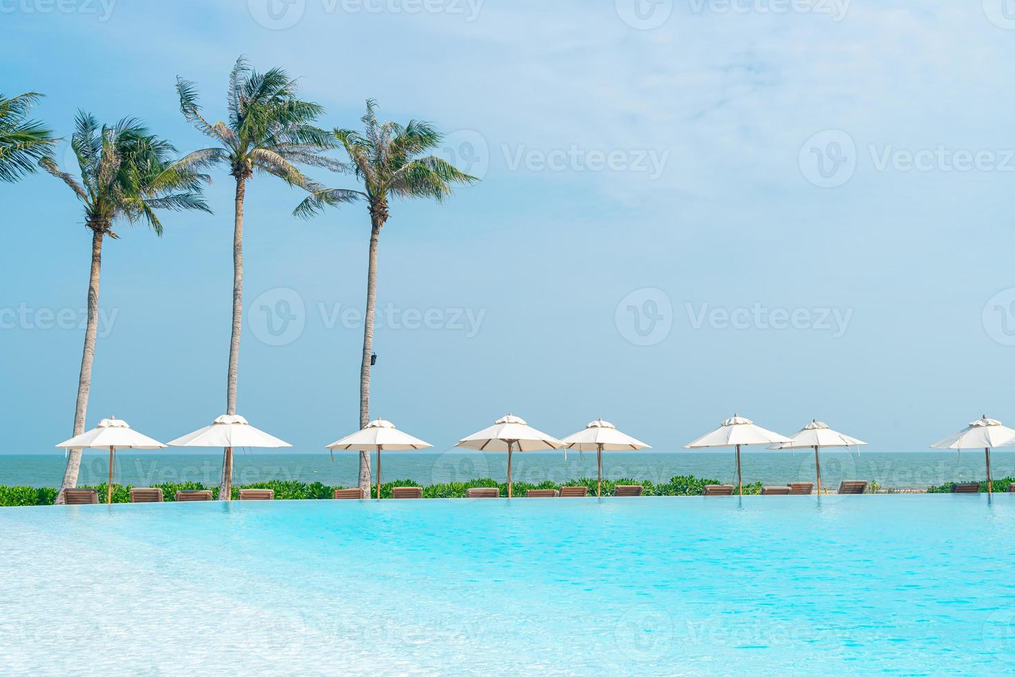 umbrella with bed pool around swimming pool with ocean sea background