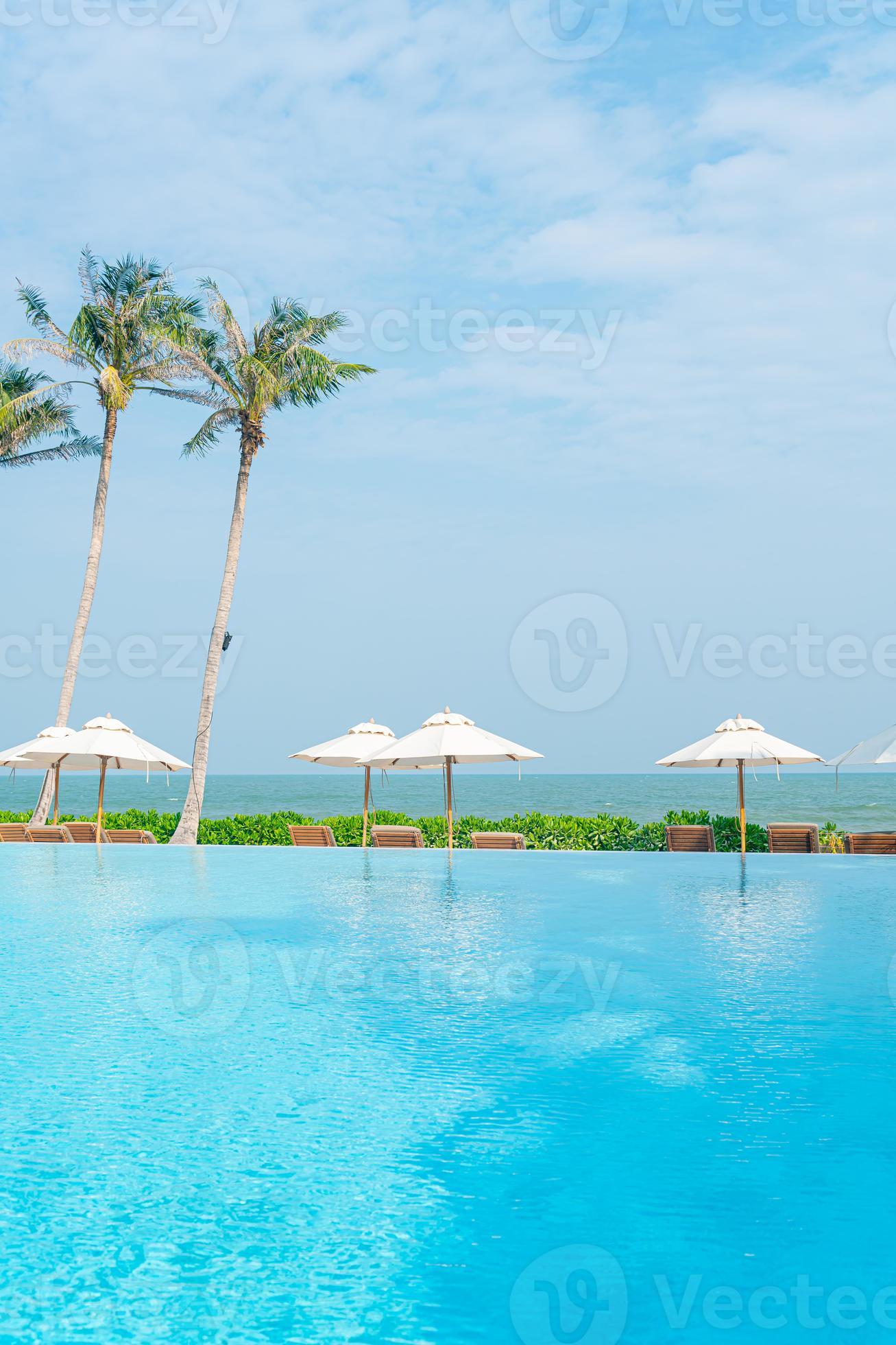 umbrella with bed pool around swimming pool with ocean sea background
