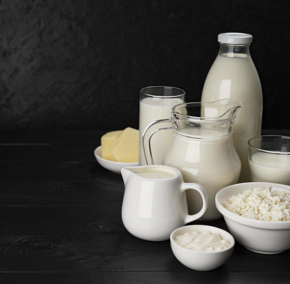 Dairy products on black wooden background photo