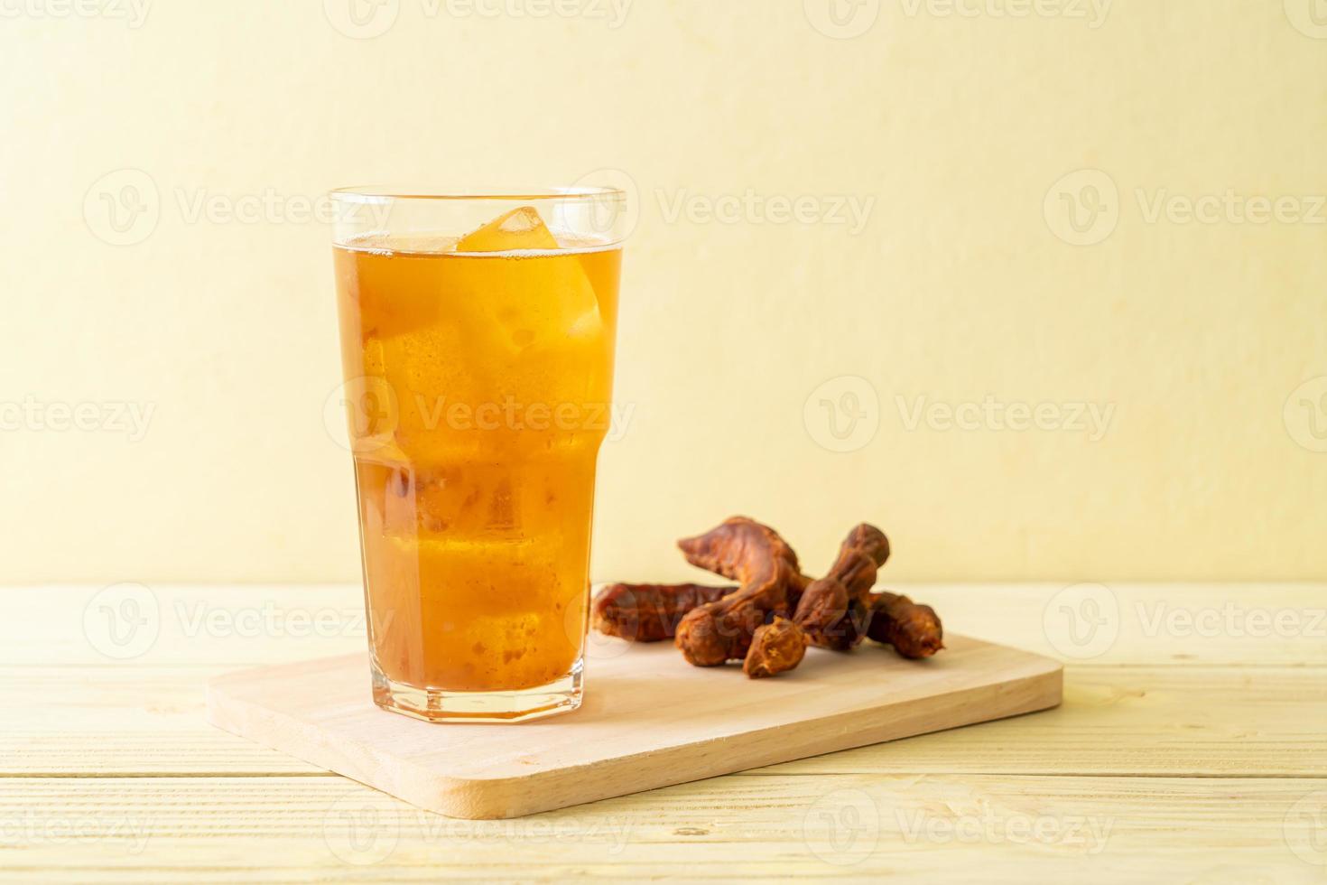 Delicious sweet drink tamarind juice and ice cube photo