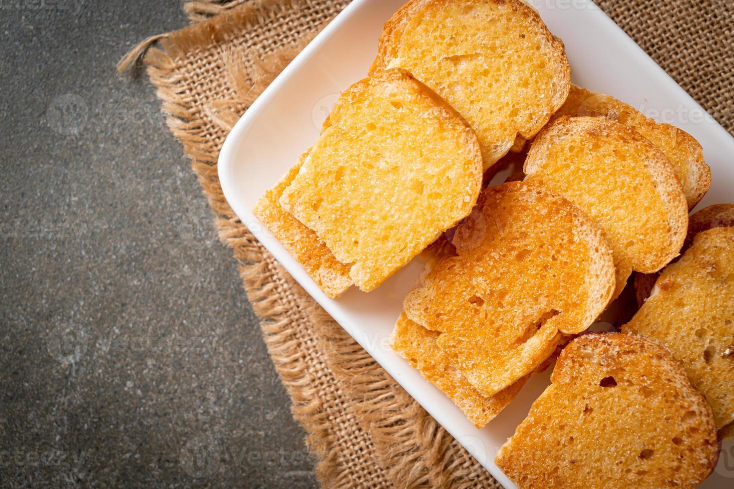 baked crispy bread with butter and sugar photo