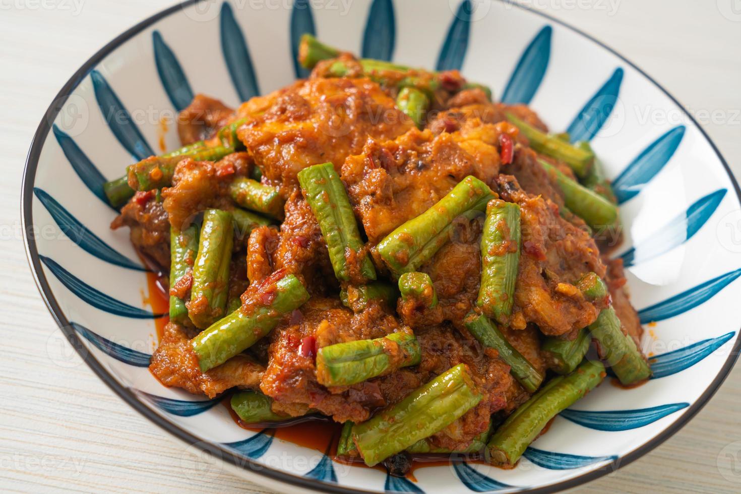 Stir fried pork with red curry paste photo