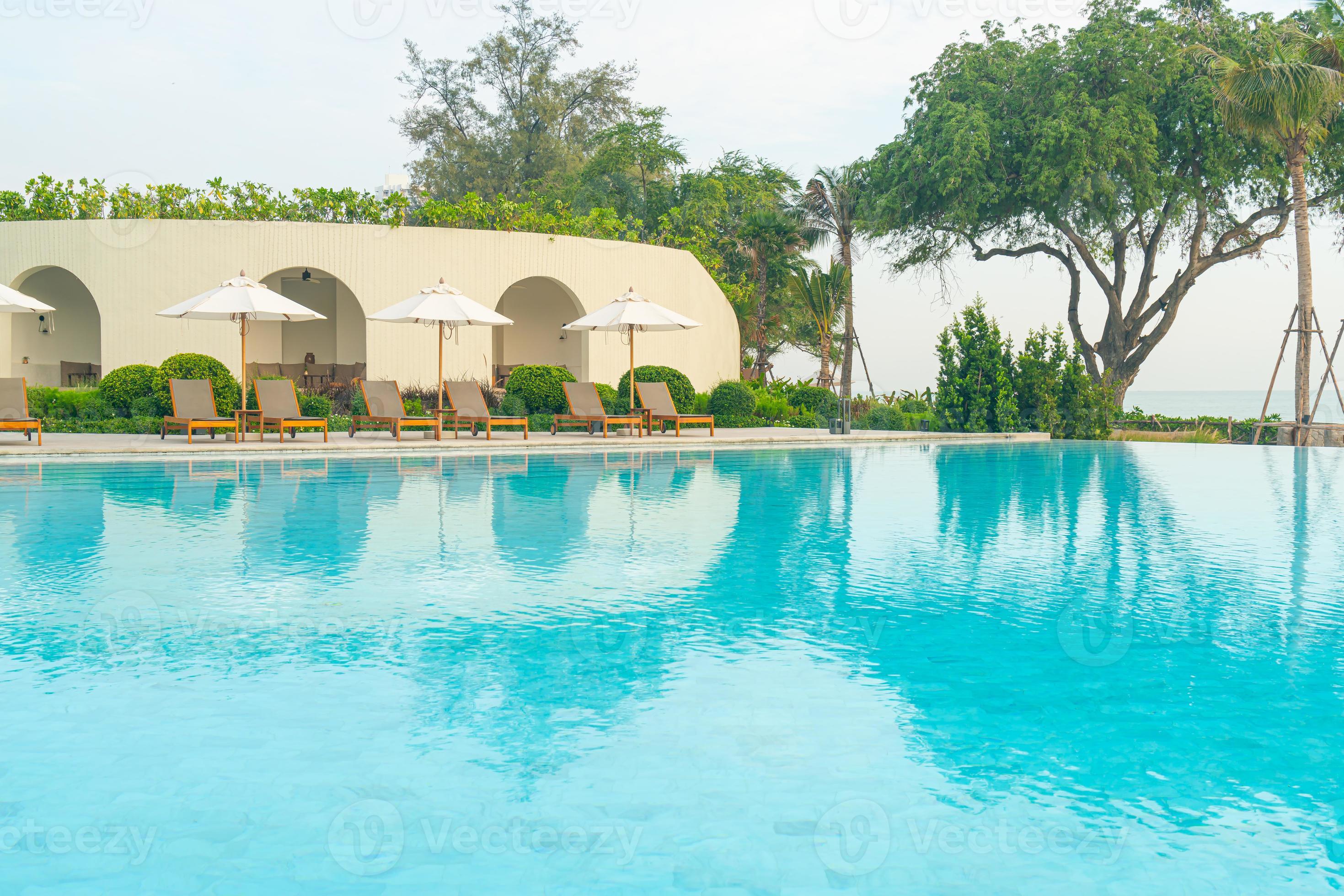 umbrella with bed pool around swimming pool with ocean sea background