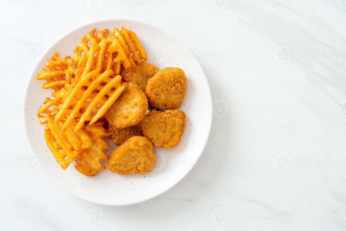 fried chicken nuggets with fried potatoes photo
