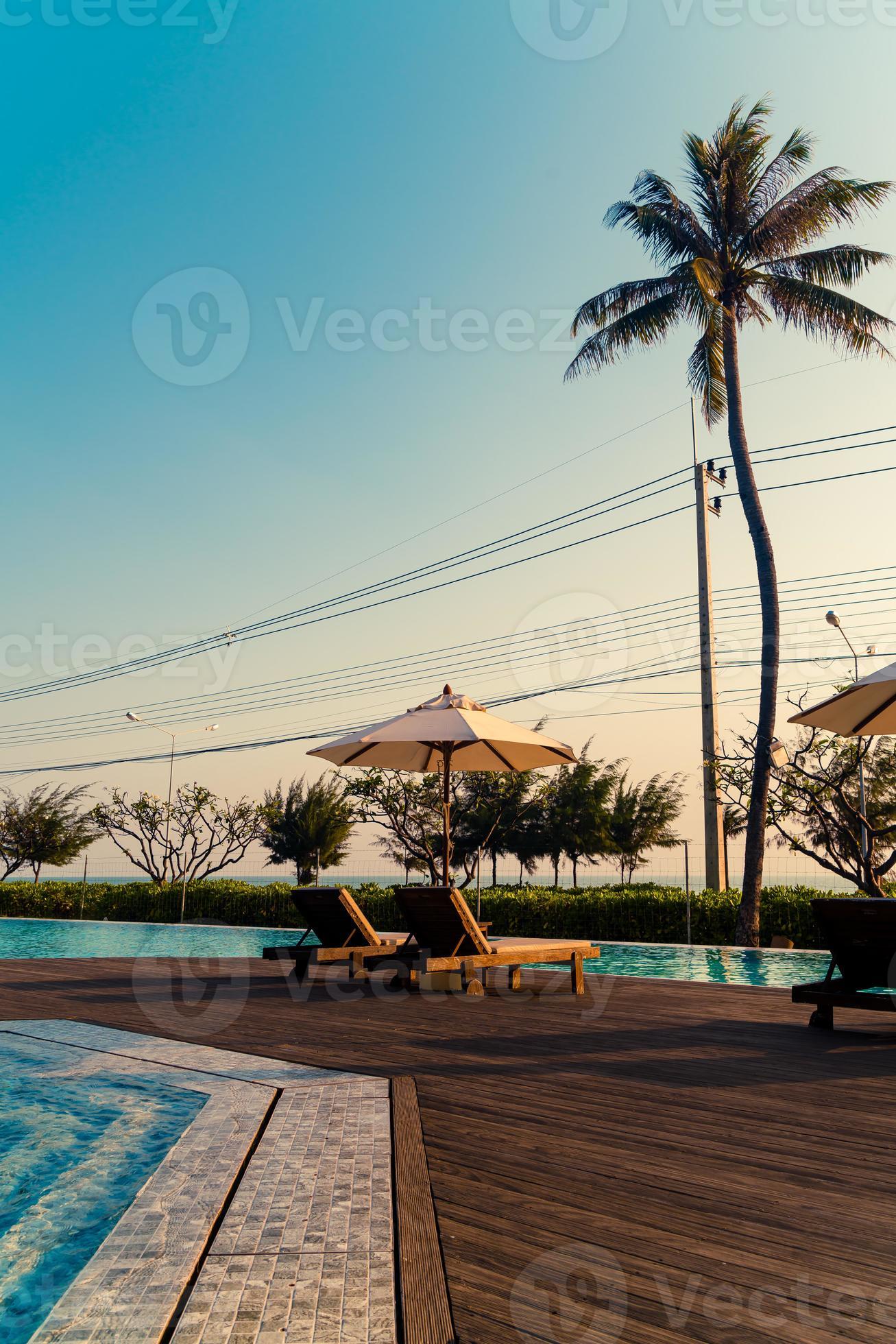 umbrella with bed pool around swimming pool with ocean sea background
