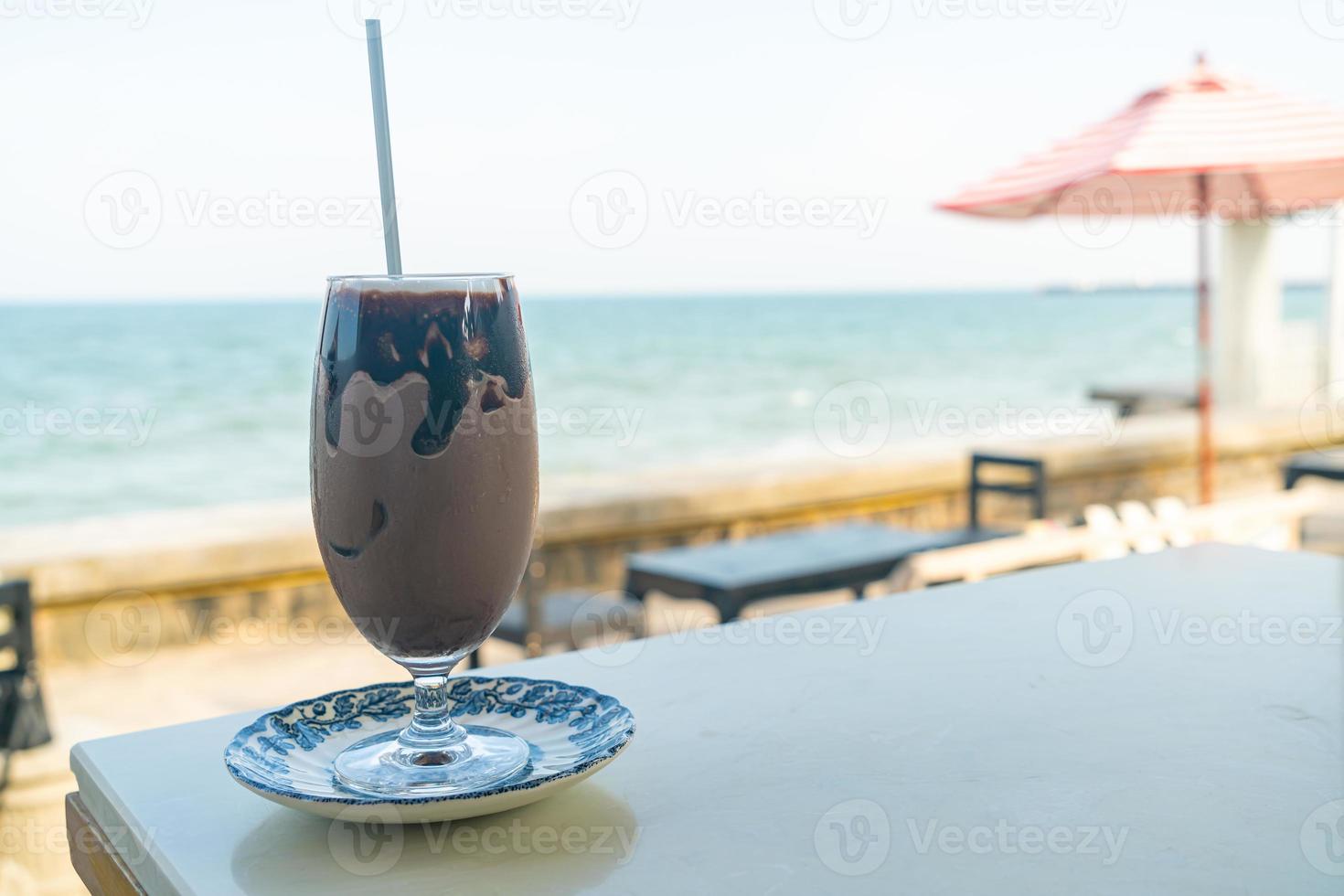 ice chocolate milkshake with sea background photo