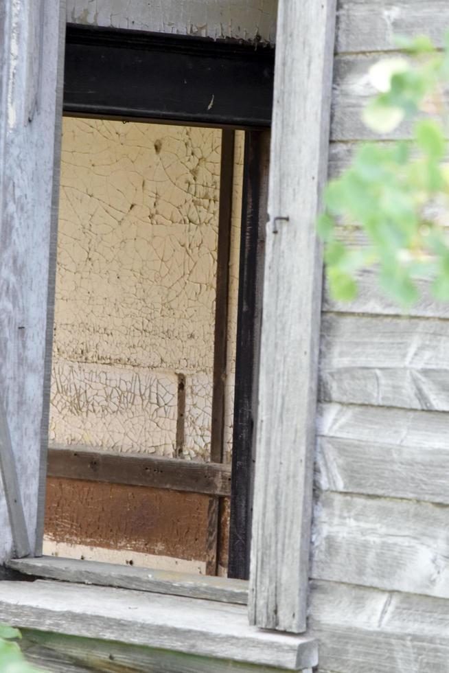 a window into an old white building photo