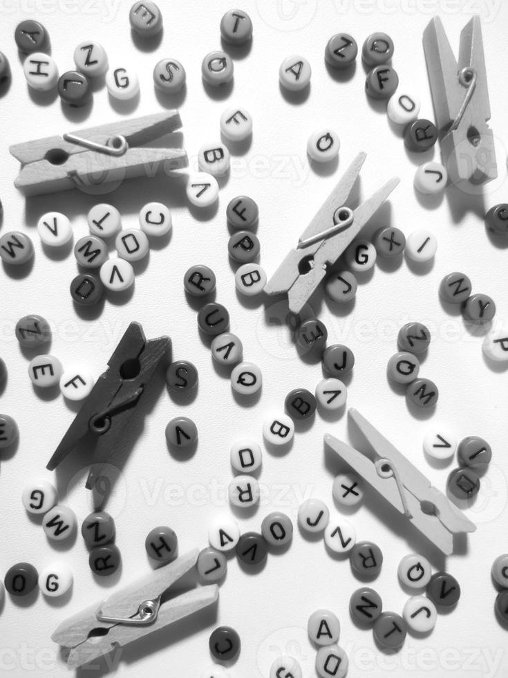Colorful alphabet and number beads on white background photo