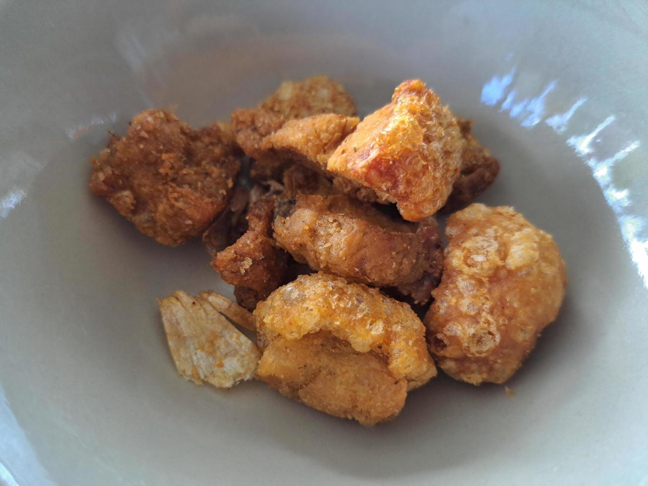 Pork skin fried on a white plate photo