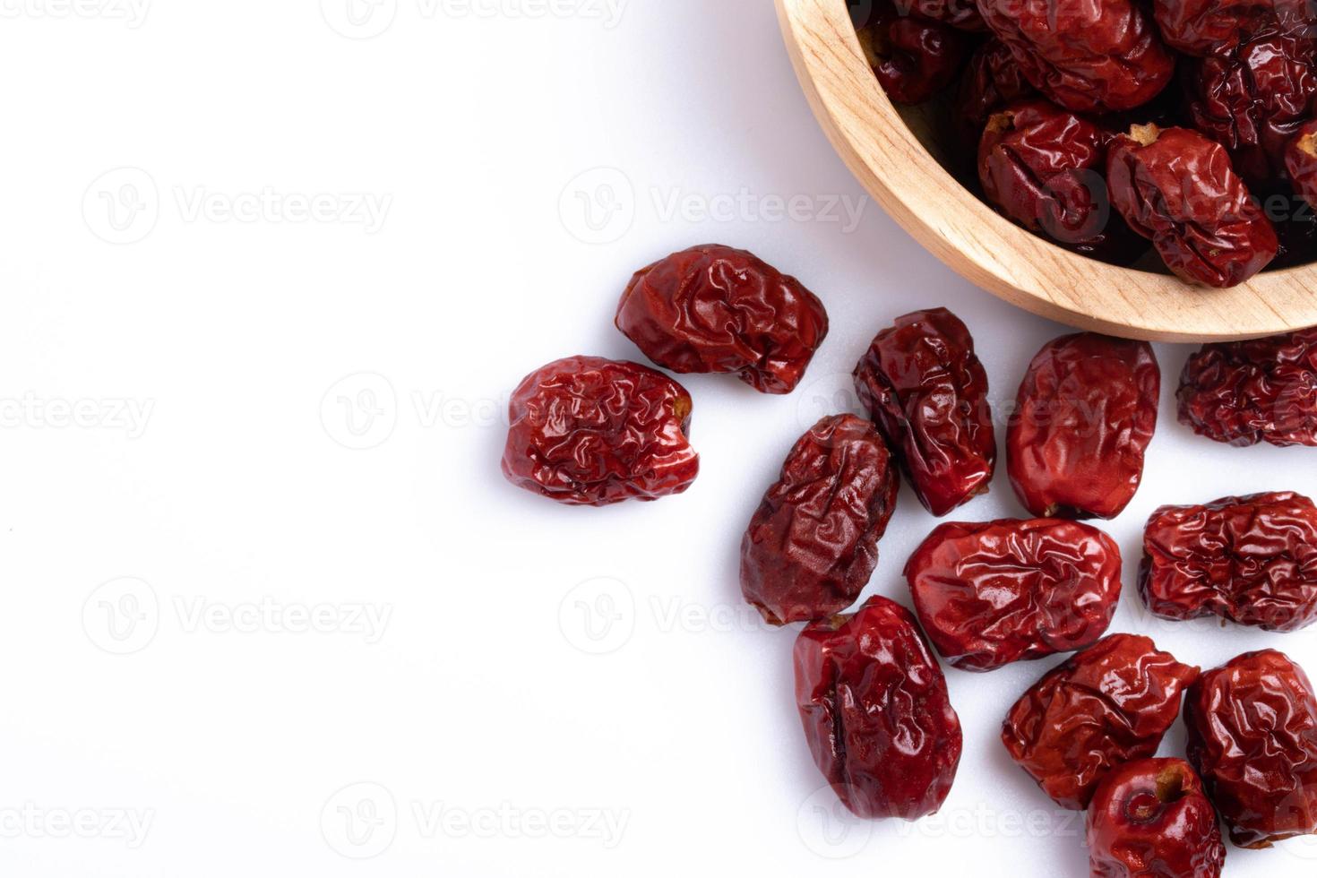 Dried Chinese jujube in a cup on white background. Isolated image. photo