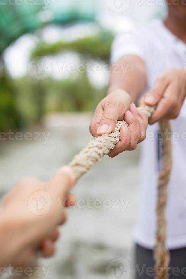 Hands pulling rope photo