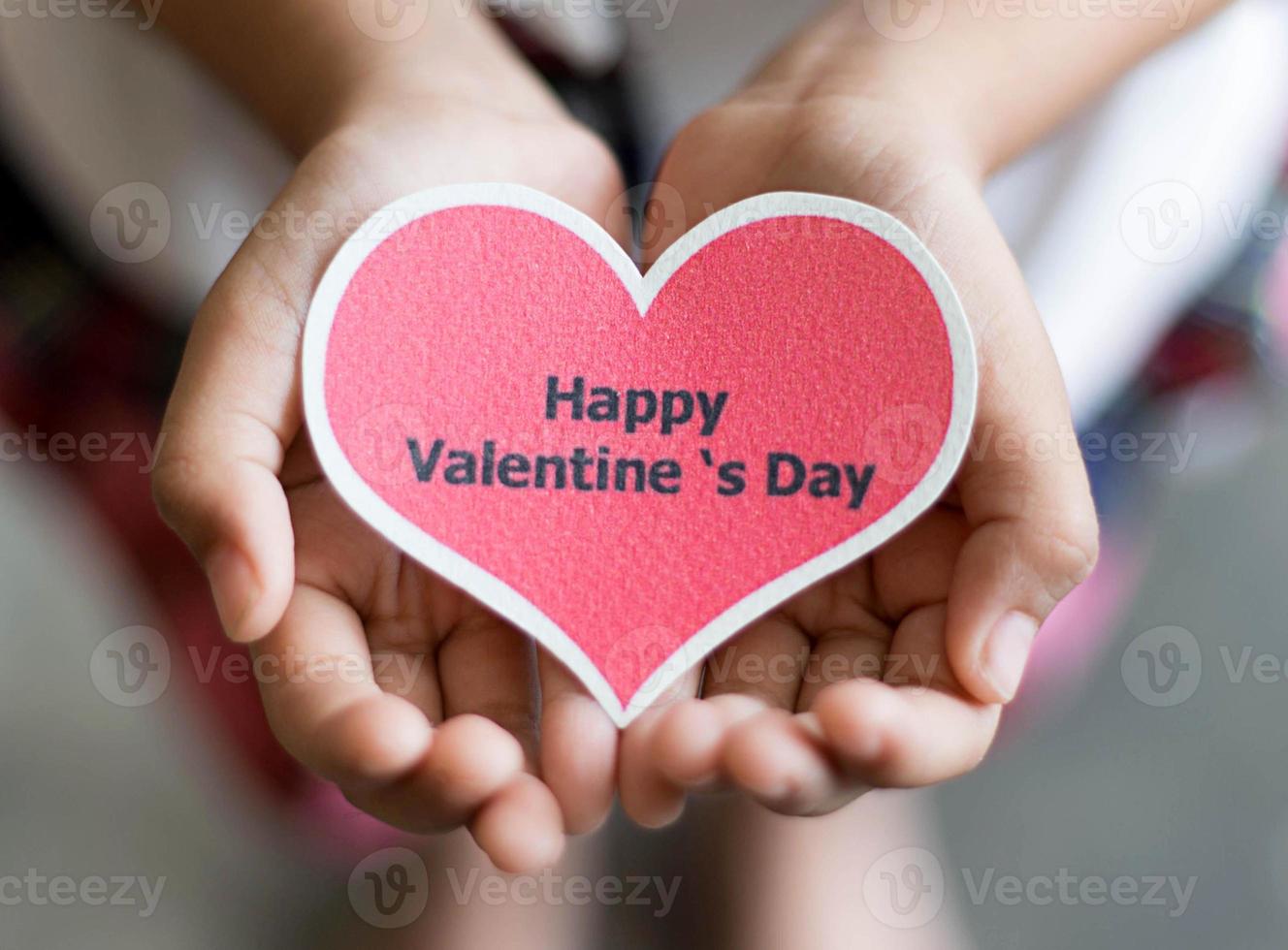 Happy valentines day card on hands photo