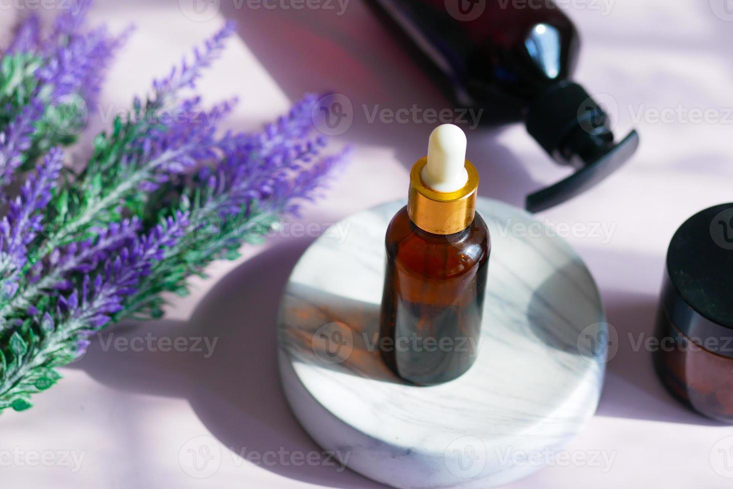 Essential lavender oil and flowers on table with copy space photo