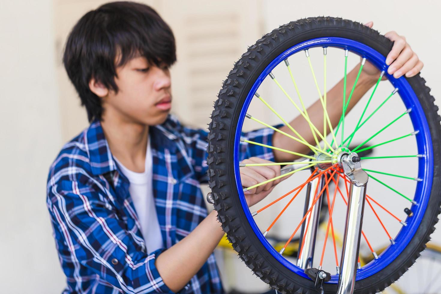 Boy fixing bicycle, Mechanical hobby and repair concepts. photo
