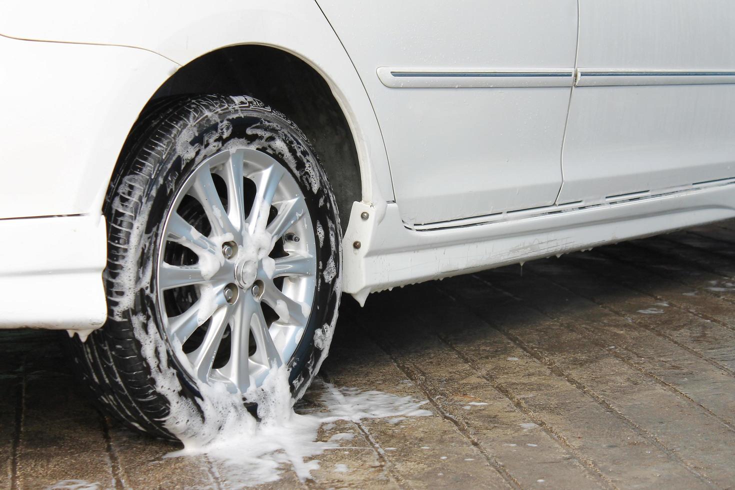 car wheel is washing in soap suds photo