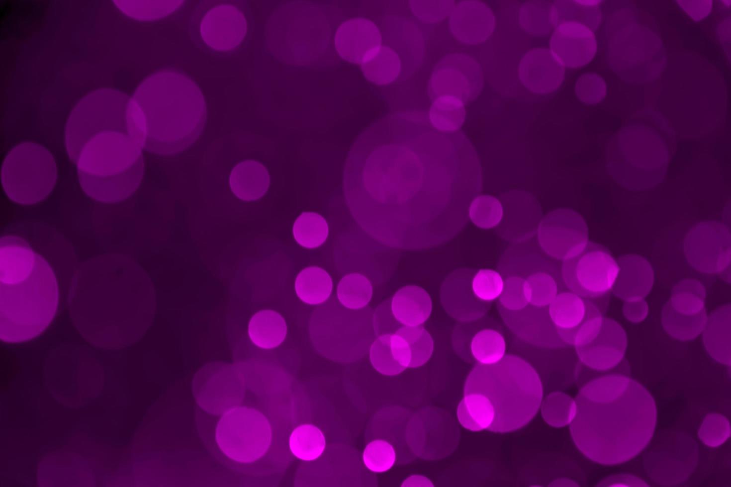 Purple bokeh abstract background caused by spray water. photo