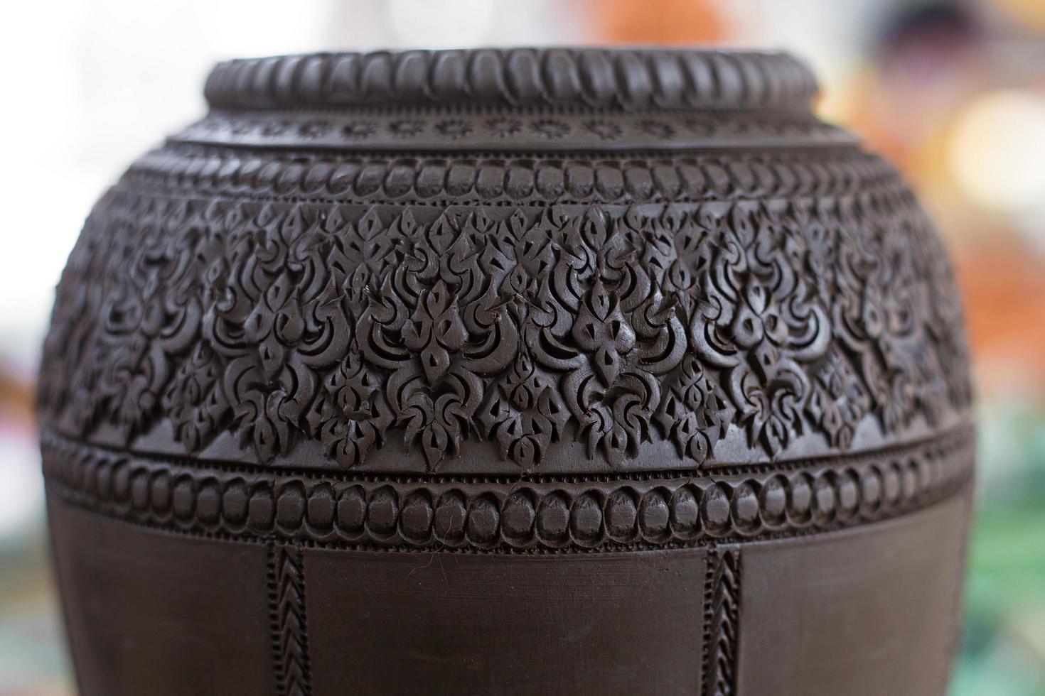 Handcrafted Carved Pottery Jar made from clay which it is Thai traditional earthenware. photo