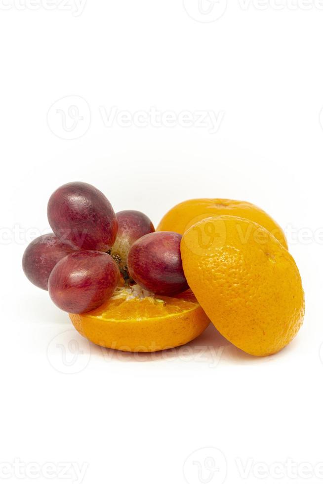 Fresh citrus fruits and grapes on a white background photo