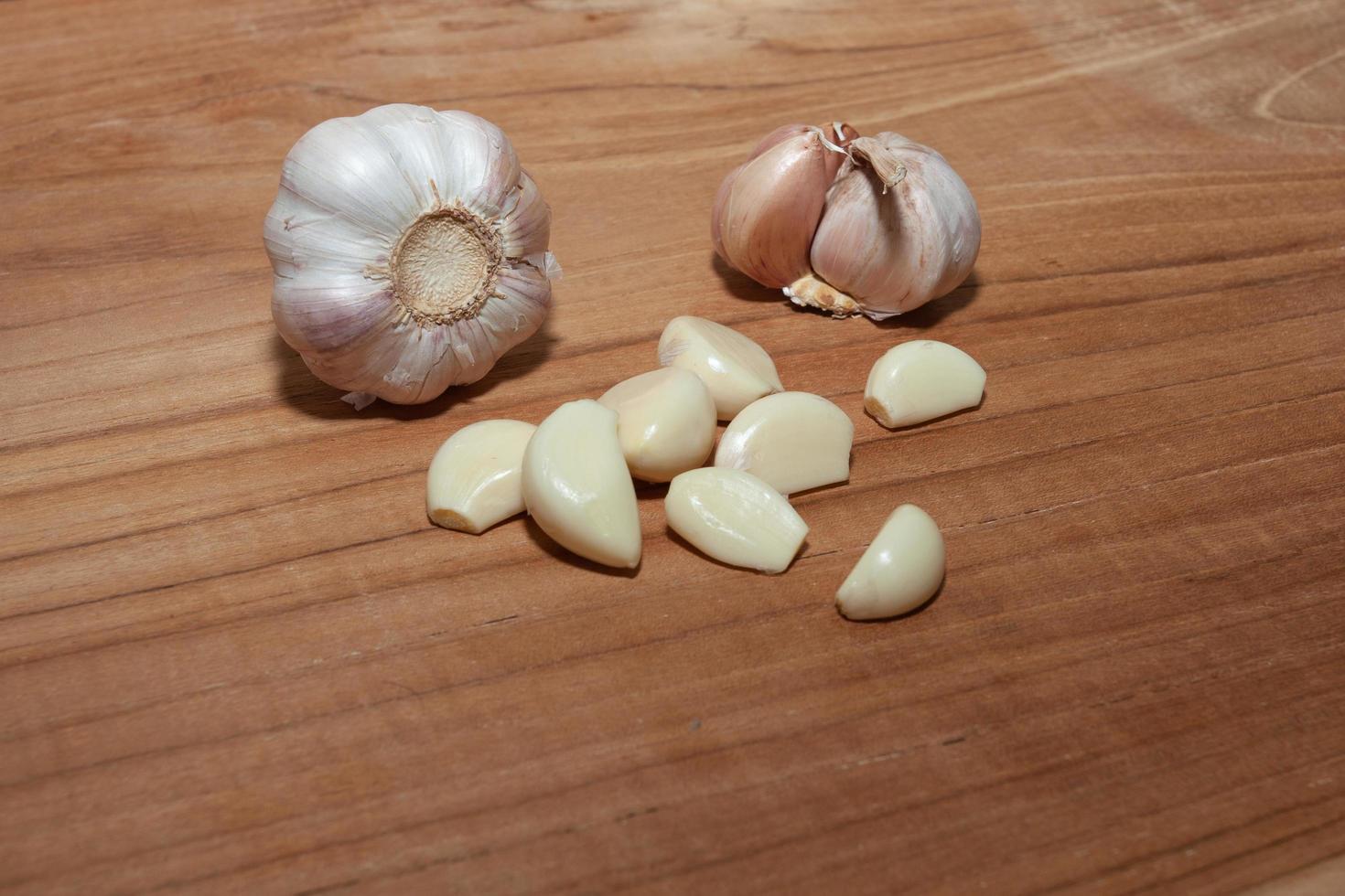 white garlic on wooden floor for cooking photo