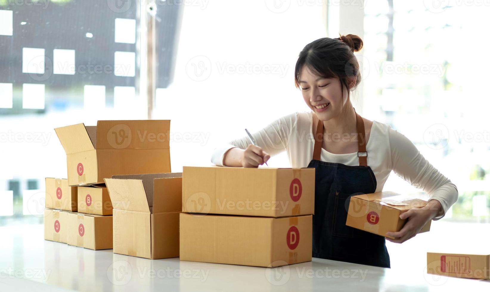 Portrait of Starting small businesses SME owners female entrepreneurs working on receipt box and check online orders to prepare to pack the boxes, sell to customers, sme business ideas online. photo