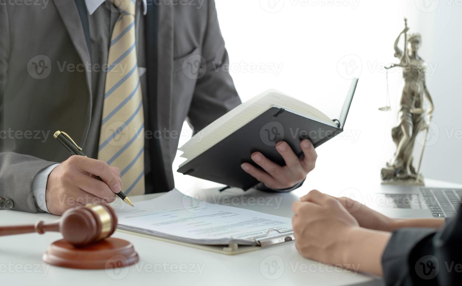 Business woman and lawyers discussing contract papers with brass scale on wooden desk in office. Law, legal services, advice, Justice concept. photo