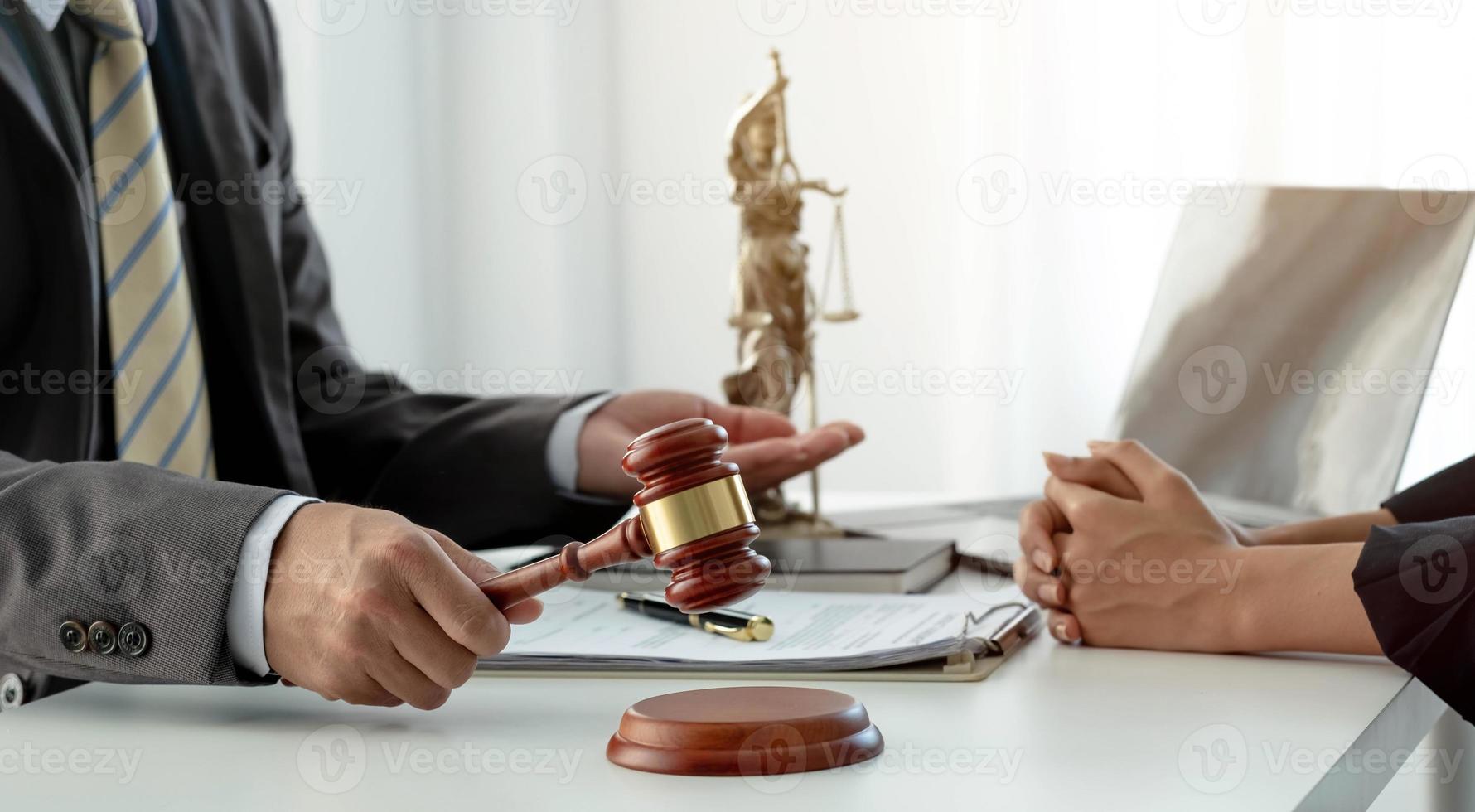 Business and lawyers discussing contract papers with brass scale on desk in office. Law, legal services, advice, justice and law concept picture with film grain effect photo