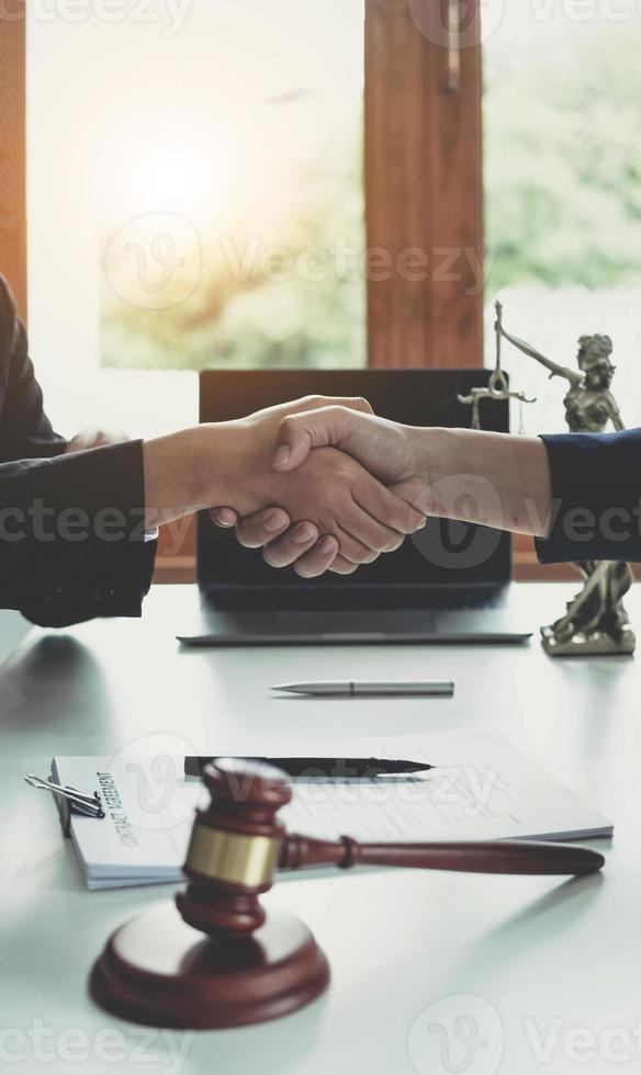 Businessman shaking hands to seal a deal with his partner lawyers or attorneys discussing a contract agreement. photo