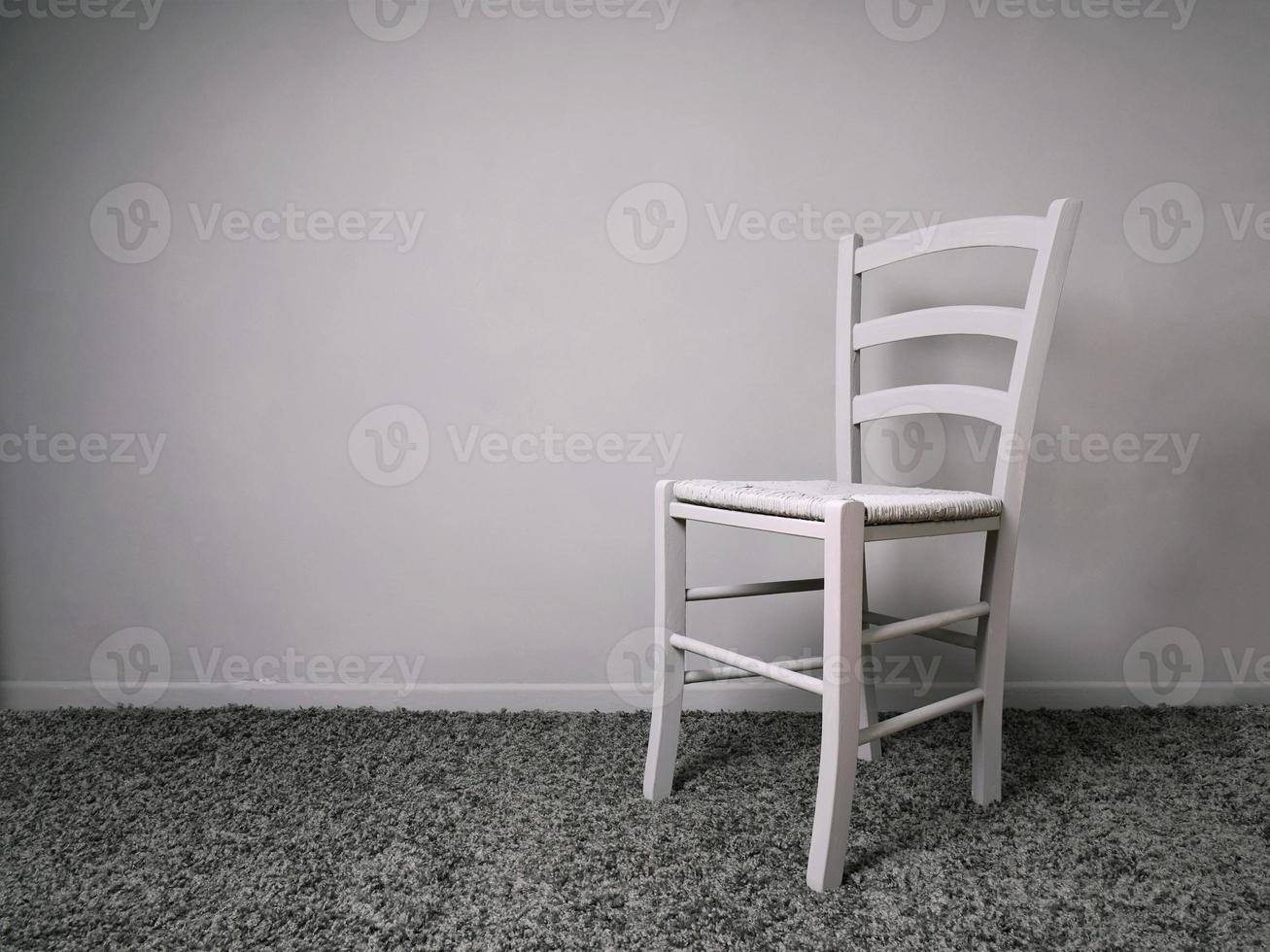 entirely gray room with empty chair and copy space photo