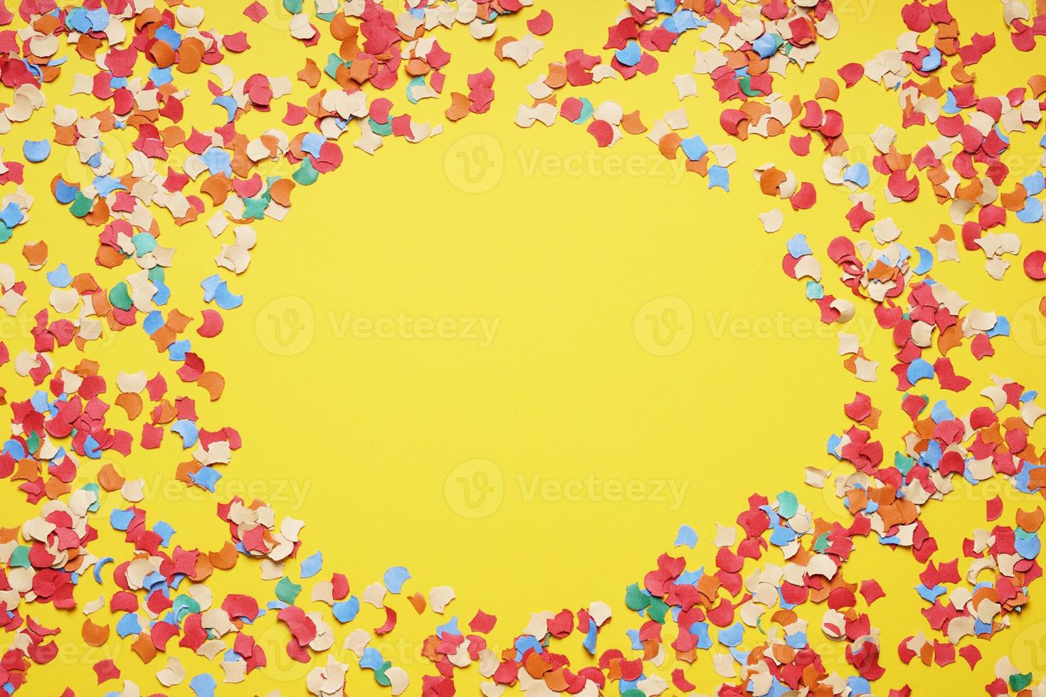 confetti frame border on yellow paper background photo