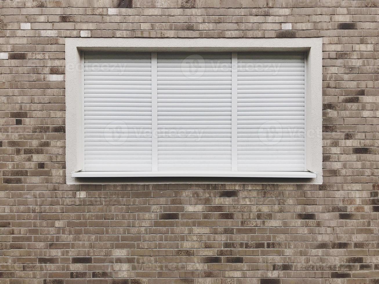 closed window with rolling shutters or roller blinds photo