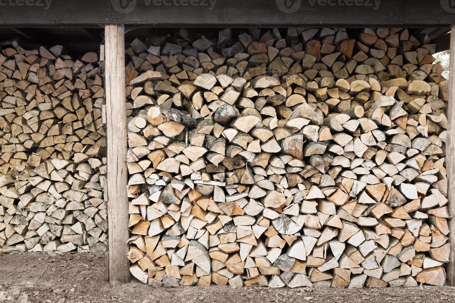 stacked firewood in wood shed photo