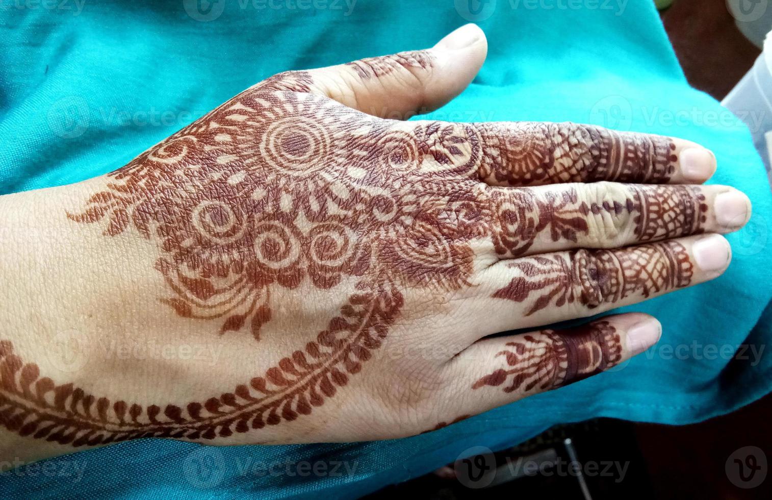 Popular Mehndi Designs for Hands or Hands painted with Mehandi Indian traditions photo