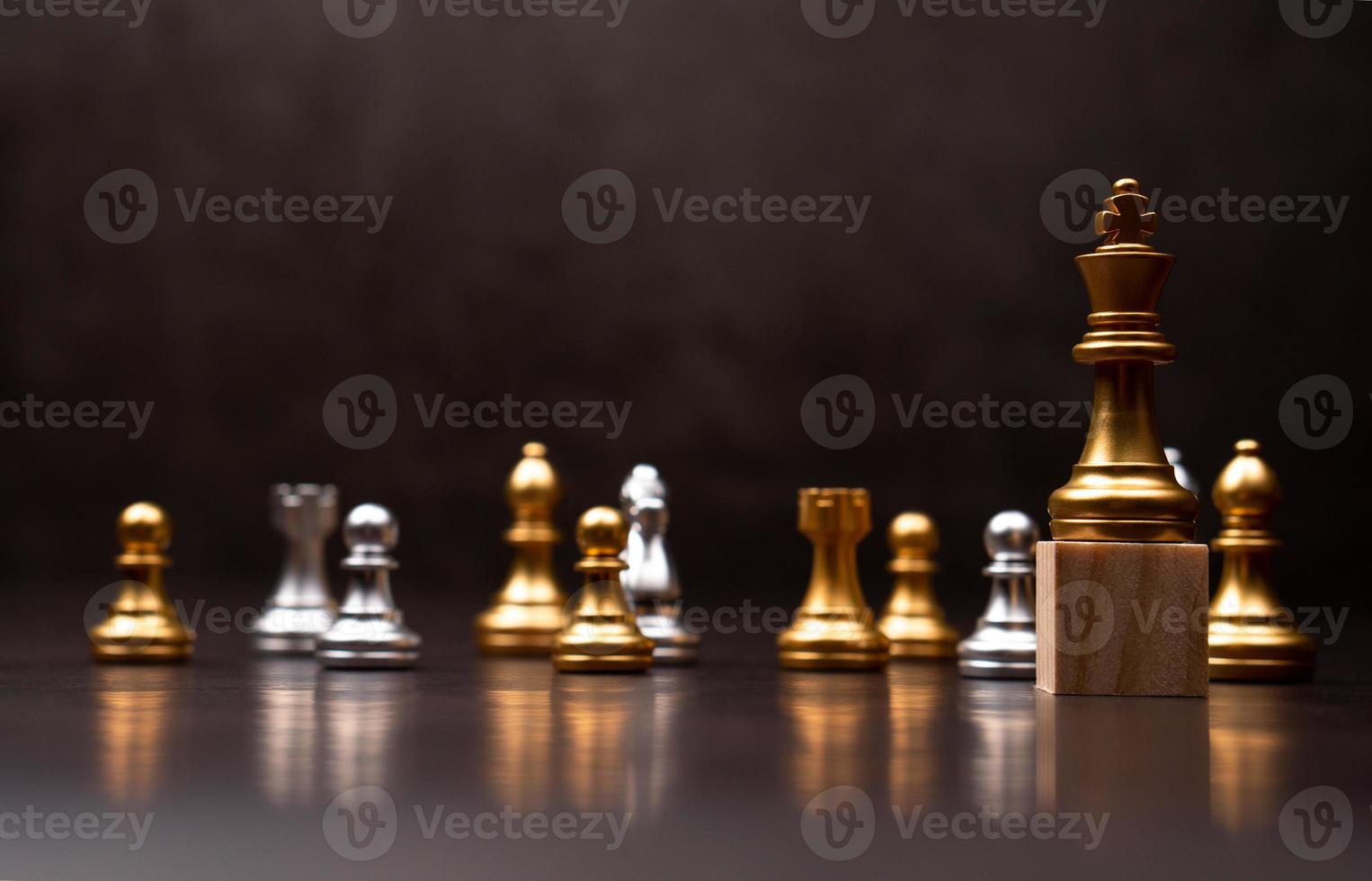 Golden king chess standing on a wooden stand. The concept of Leaders in good organizations must have a vision and can predict business trends and assess competitors photo