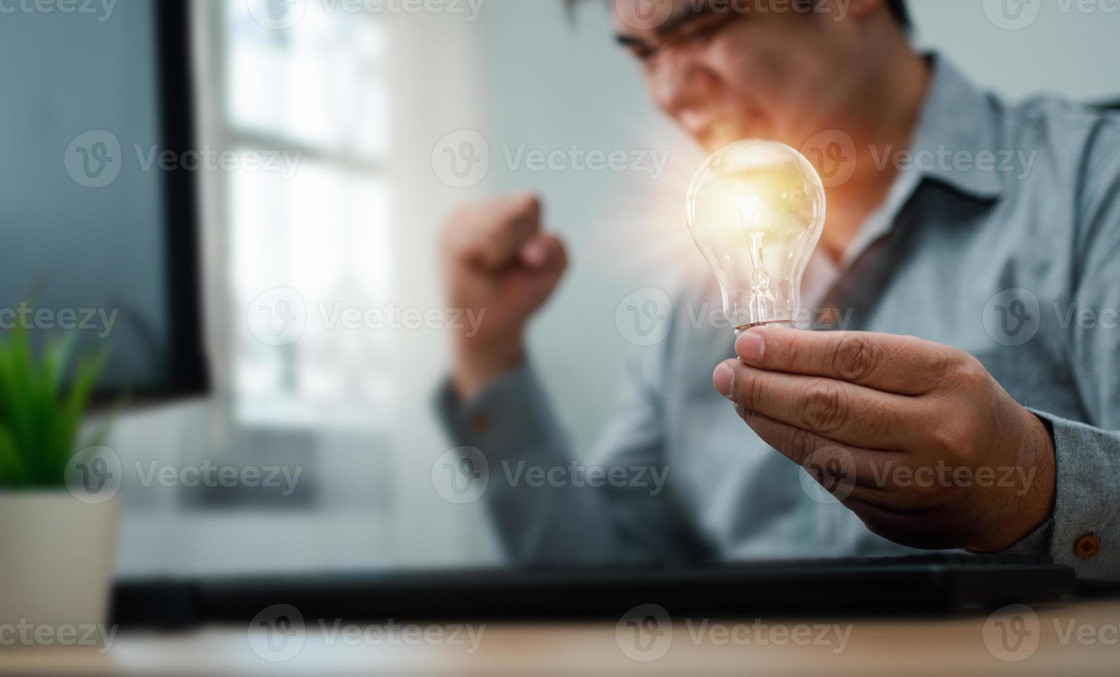 Businessman holding lightbulb and feeling delighted and excited by new innovation and ideas for success business panels.Concept of innovation creative technology ideas for Business solution photo