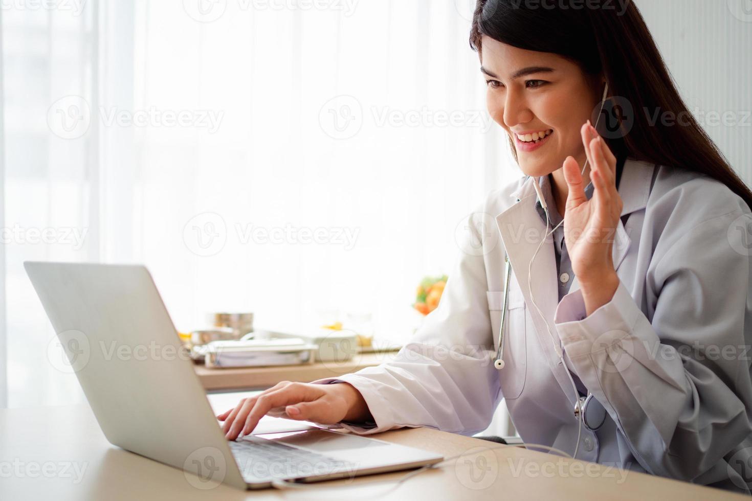 Asian therapist woman doctor is online visiting with a patient on the internet application. Her Listening and Give advice and explains how to treat the initial disease, Concept of Medical technology. photo