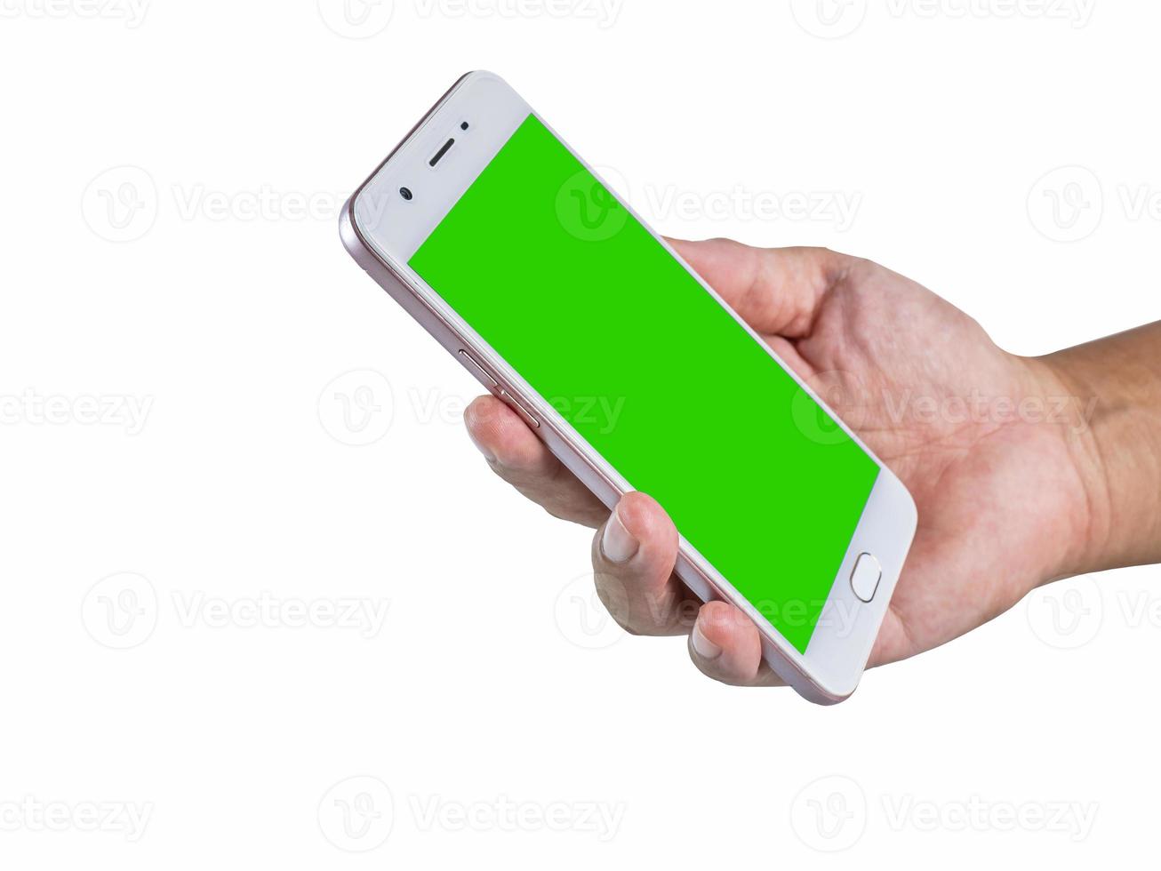 hand holding a white cell phone The screen was cut into a green scene. Ready to continue working and have clipping path on isolated background photo