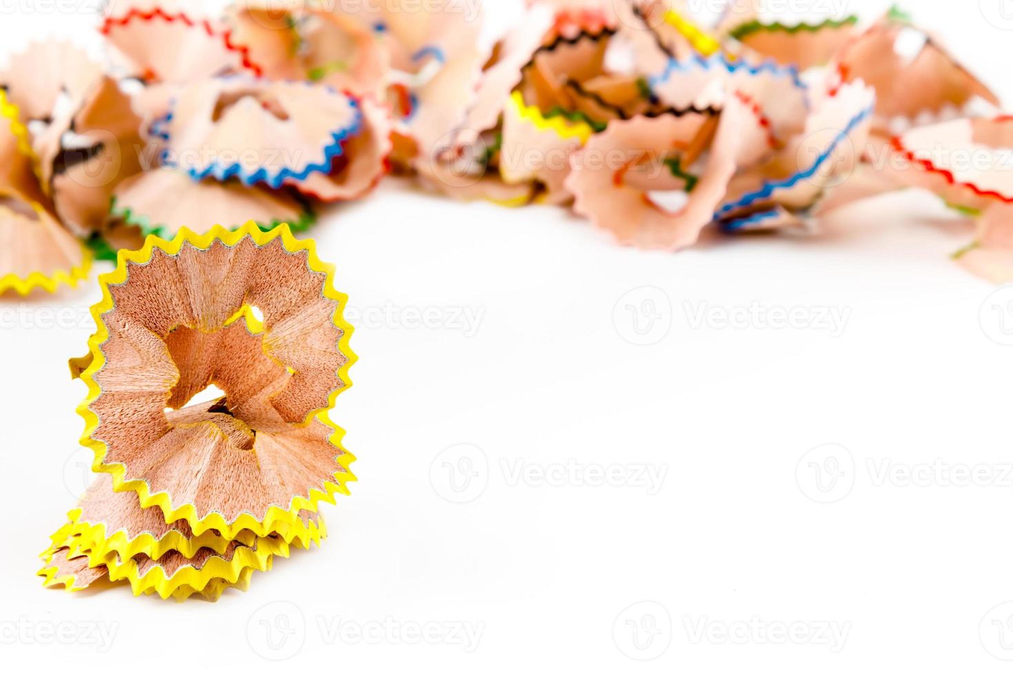 Yellow pencil shavings with more shavings at the background. Horizontal image. photo
