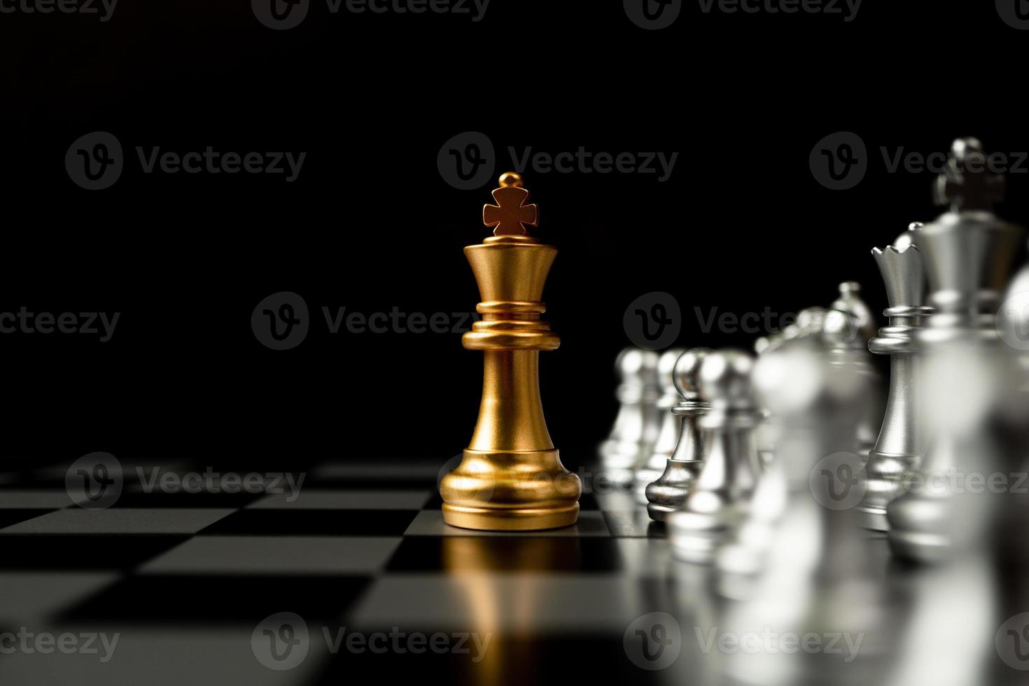 Golden King chess standing in front of other chess, Concept of a leader must have courage and challenge in the competition, leadership and business vision for a win in business games photo