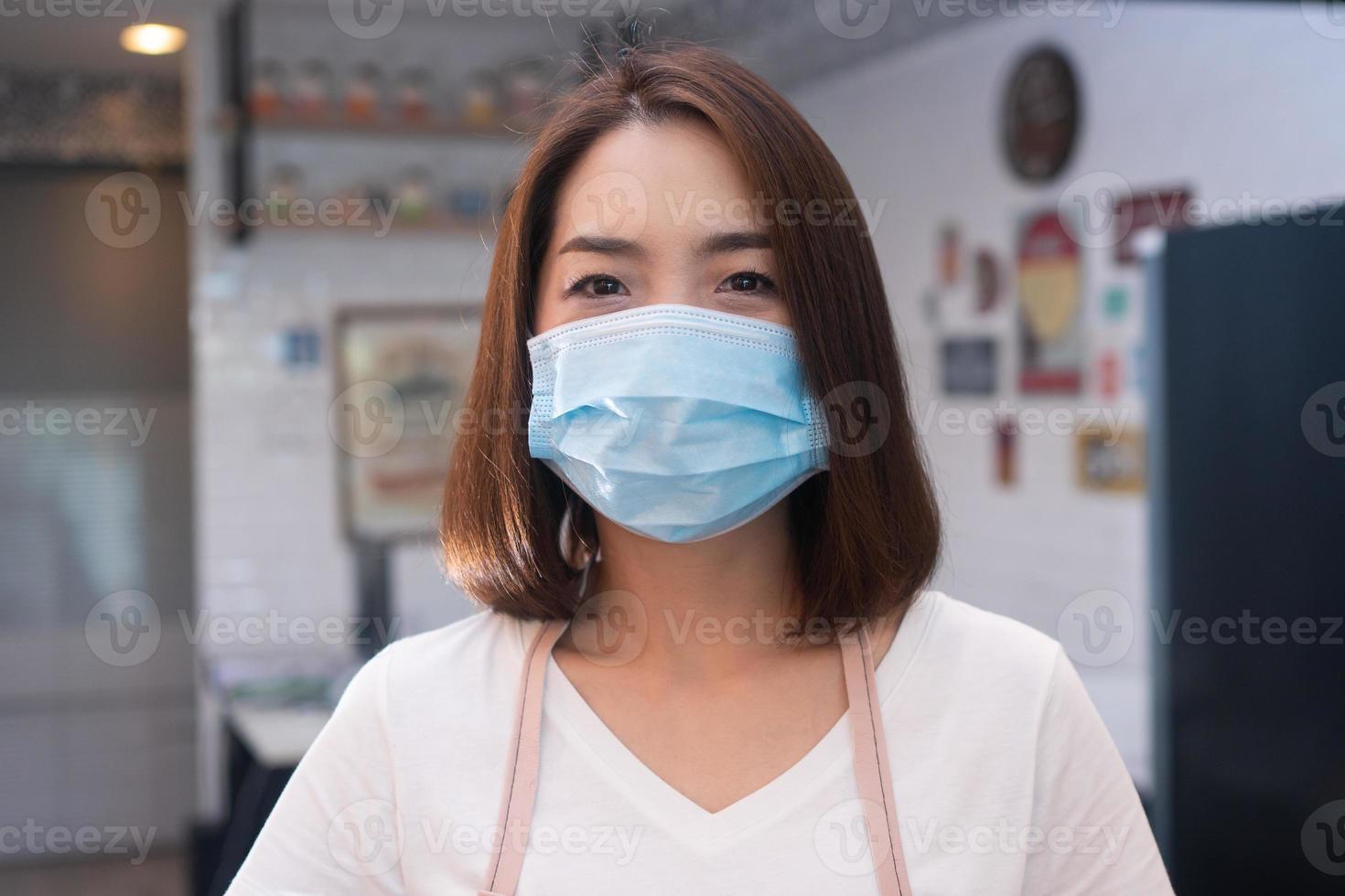 Asian barista women wearing face masks to prevent contagious diseases and serve customers in the coffee shop. The concept of prevention from COVID 19 photo