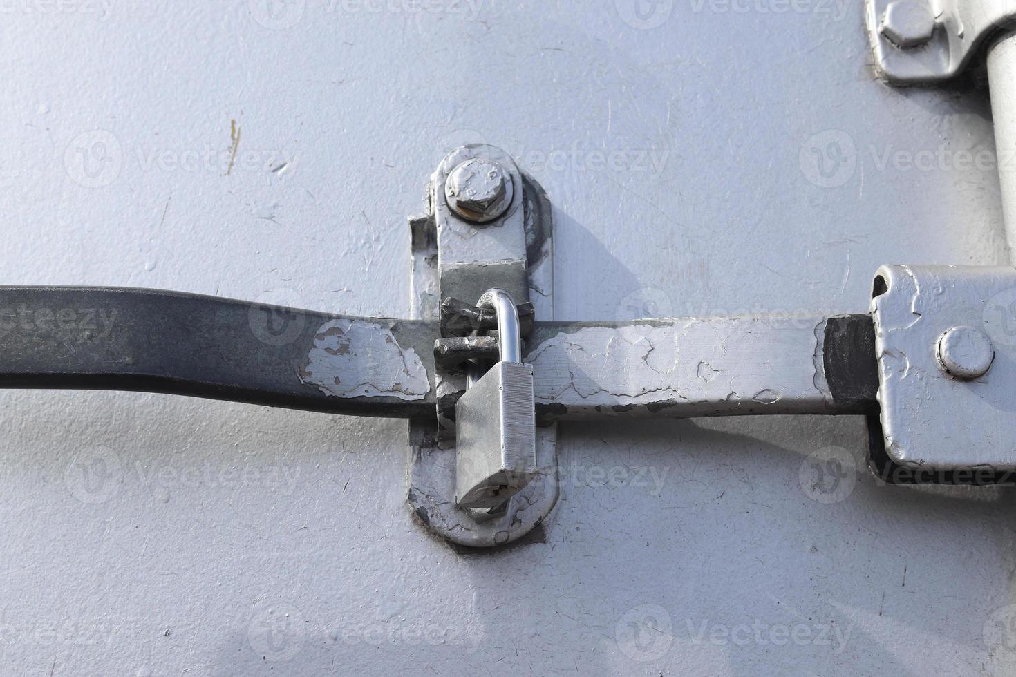 Detailed close up view on metal and steel surfaces on a silver cargo containter photo