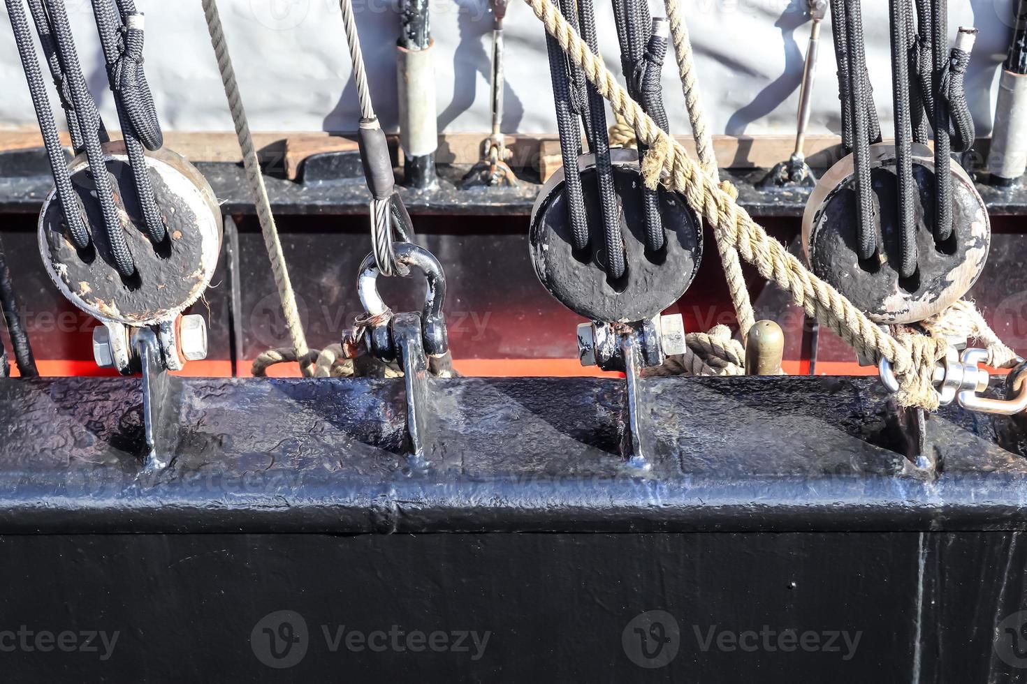 Detailed close up detail of ropes and cordage in the rigging of an old wooden vintage sailboat photo