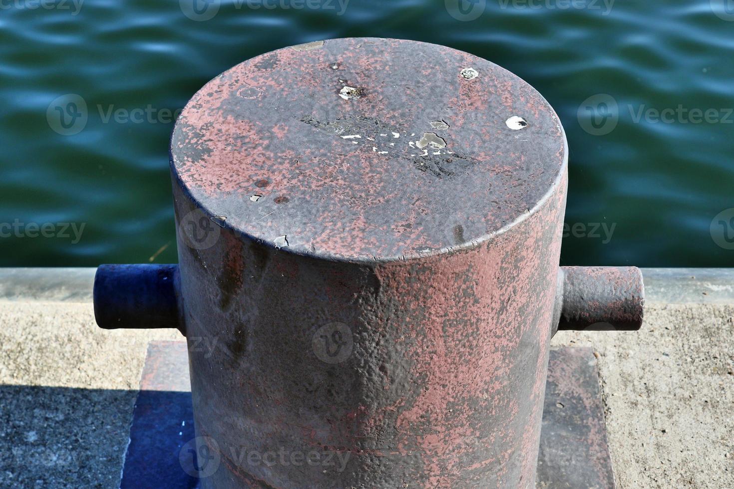 Different bollards and technical installations of vessel traffic at a port photo
