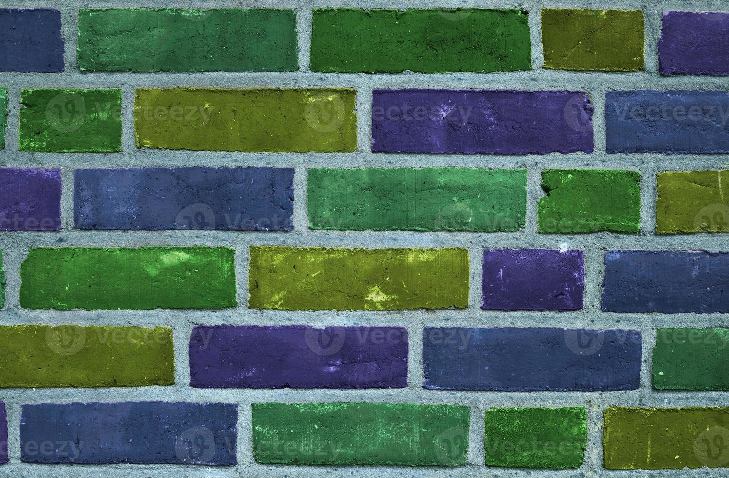 Beautiful rainbow colored bricks on an old and weathered wall texture photo