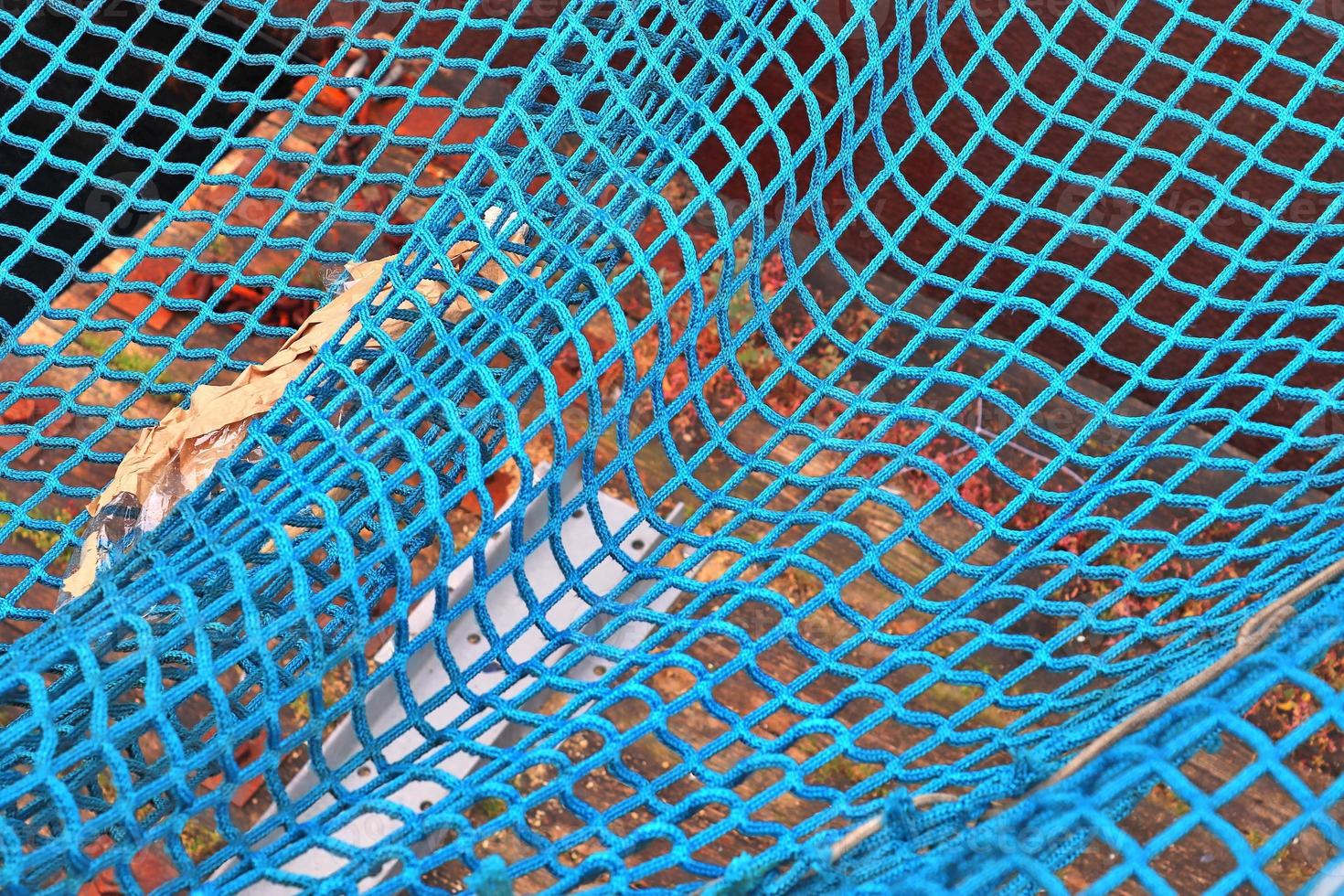 Close up on a blue fishing net at the harbour of Kiel in Germany photo