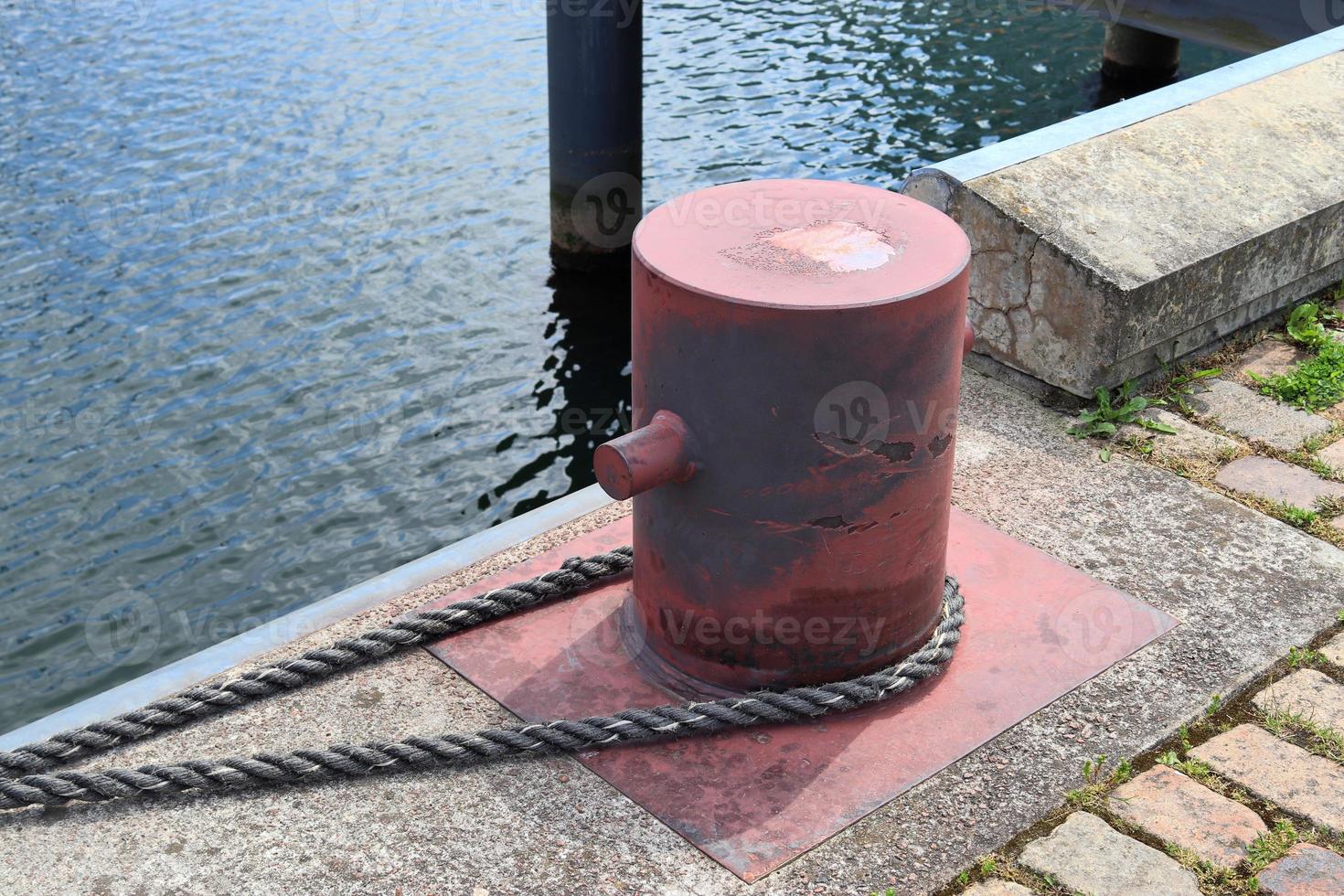 Different bollards and technical installations of vessel traffic at a port photo